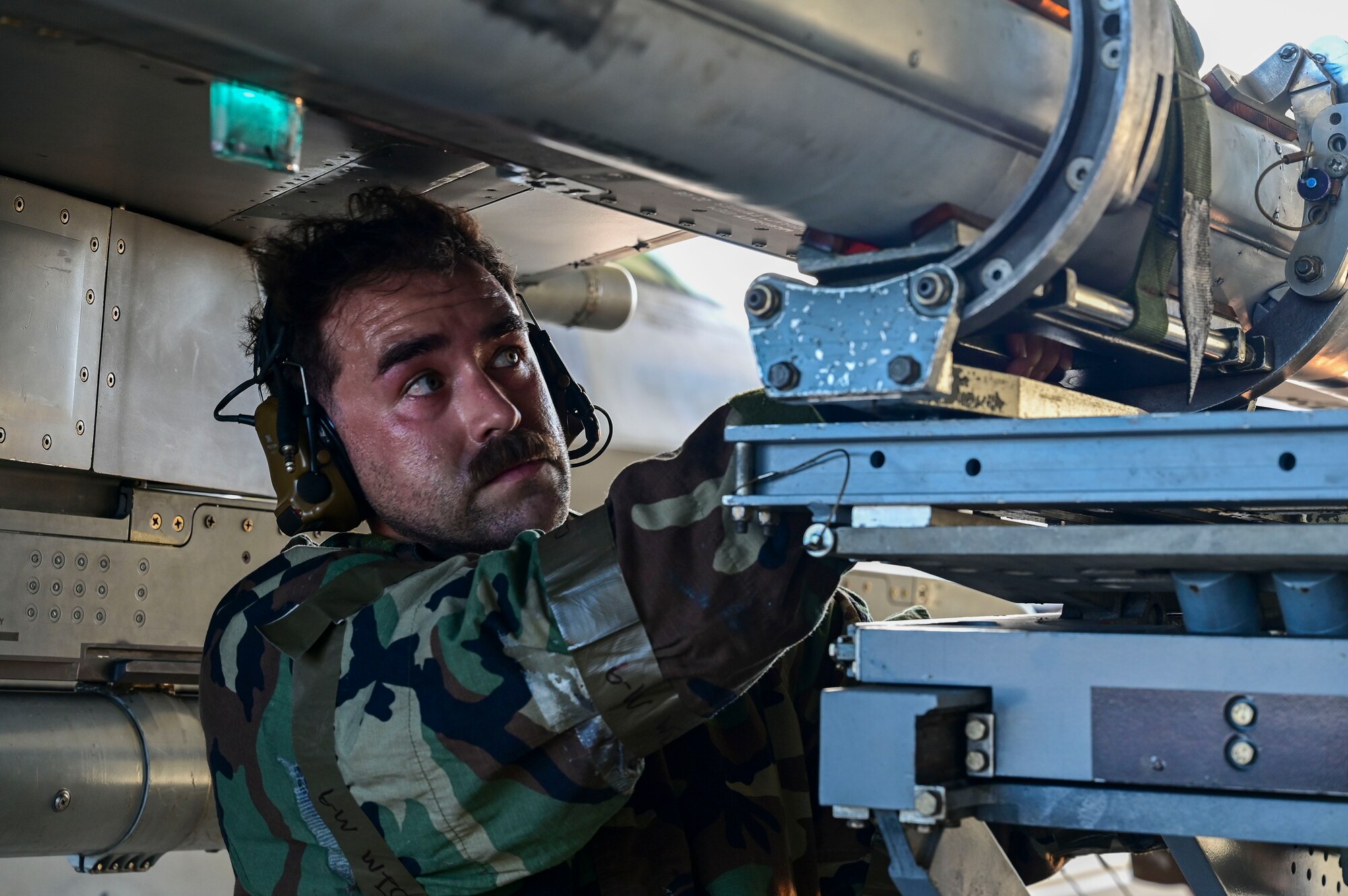 A man grasps a munition.