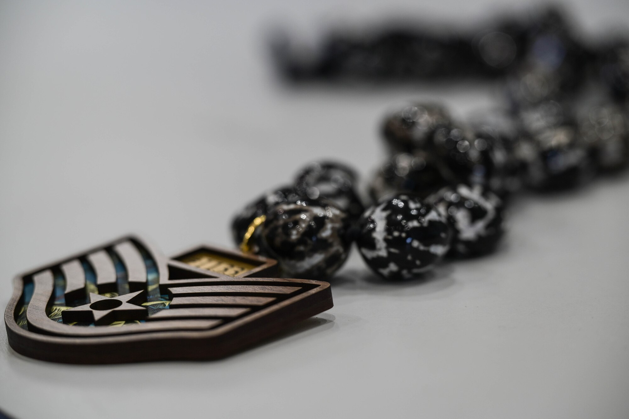 A staff sergeant pendant laying flat on a table.