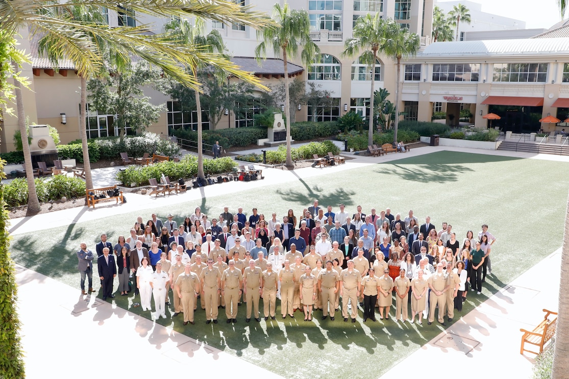 KISSIMMEE, Fla. (Aug. 5, 2025) Navy Medicine Research & Development (NMR&D) personnel pose for a group photo on the second day of the 2025 Military Health System Research Symposium (MHSRS). MHSRS is the DoD’s premier scientific meeting that focuses specifically on the unique medical needs of service members. This annual educational symposium brings together healthcare professionals, researchers, and DoD leaders for four days of critical learning, intensive idea sharing and relationship building. NMR&D, a global collective of eight commands conducts research in support of Navy, Marine Corps and joint U.S. warfighter health, readiness and lethality, across a broad spectrum of activity from basic science in the laboratory to field studies in austere and remote areas of the world to investigations in operational environments. NMR&D studies infectious diseases, biological warfare detection and defense, combat casualty care, environmental health concerns, directed energy health effects, aerospace and undersea medicine, medical modeling, simulation, operational mission support, epidemiology and behavioral sciences. (U.S. Navy Photo by Tommy Lamkin/ released)