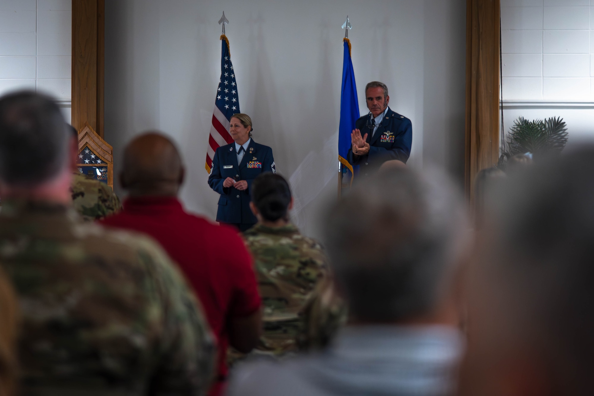 Senior Master Sgt. Spring Walden stands on stage and addresses the attendees at her retirement ceremony.