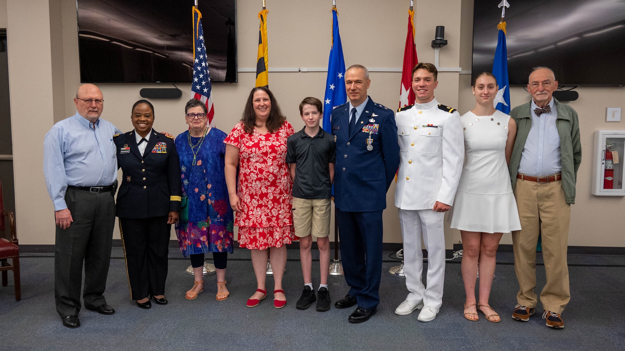Maryland Air National Guard Maj. Gen. Matthew D. Dinmore,  the National Guard assistant to the commander, U.S. Cyber Command, and director, National Security Agency and Central Security Service, poses for a photo with his family during his retirement ceremony at Warfield Air National Guard Base at Martin State Airport, August 10, 2025. Dinmore served honorably since 1992, retiring with 33 years of service in the United States Air Force. (U.S. Air National Guard photo by Airman 1st Class Sarah Hoover)