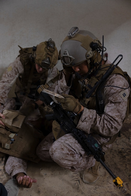U.S. Marine Corps Capt. David Min, right, an air officer with 2nd Air Naval Gunfire Liaison Company, II Marine Expeditionary Force Information Group, calls in a simulated nine line evacuation request during exercise Burmese Chase 25 at Marine Corps Base Camp Lejeune, North Carolina, Aug. 8, 2025. Burmese Chase is an annual U.S. led, multi-lateral training exercise comprised of integrating ground and air fires, infantry tactics and naval gunfire alongside NATO allies to enhance combat readiness and interoperability. (U.S. Marine Corps photo by LCpl. Weston Lindstrom)