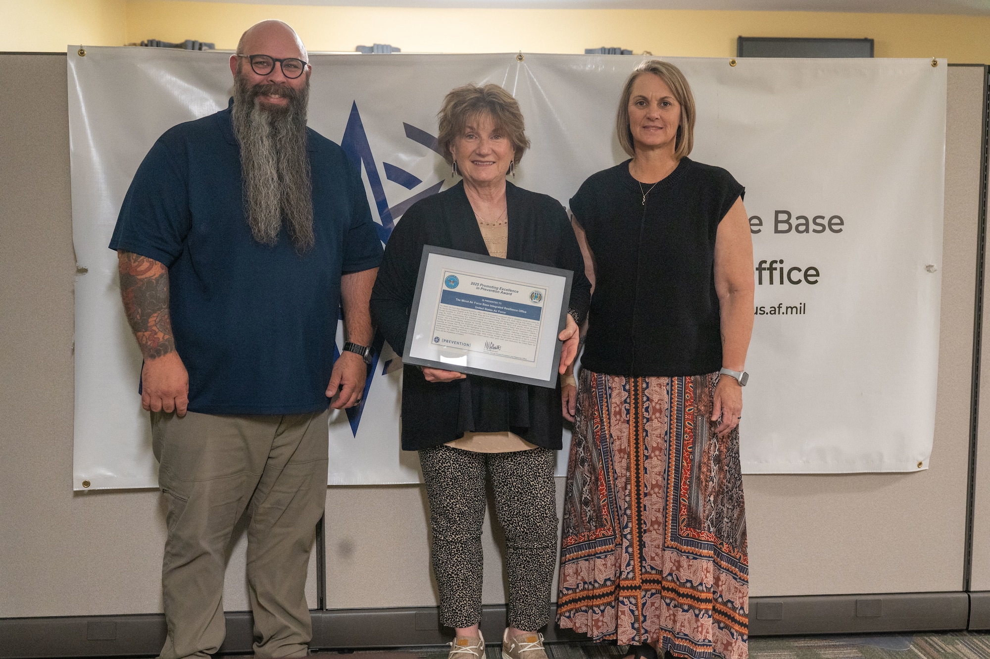 The Integrated Resilience Office (prevention) received the 2025 Promoting Excellence in Prevention award at Minot Air Force Base, July 2, 2025 . The Prevention team is led by Director Laurel Grams (middle) Chief Donita Harris (right) analyst Jeremy Meier (left). During the year the prevention office innovated their own Substance Abuse Rehabilitation Program (SARP).
