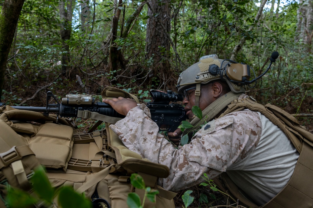 U.S. Marine Corps Sgt. Christophe Davis, a transmissions systems operator with 2nd Air Naval Gunfire Liaison Company, II Marine Expeditionary Force Information Group, posts security during exercise Burmese Chase 25 at Marine Corps Base Camp Lejeune, North Carolina, Aug. 7, 2025. Burmese Chase is an annual U.S. led, multi-lateral training exercise comprised of integrating ground and air fires, infantry tactics and naval gunfire alongside NATO allies to enhance combat readiness and interoperability. (U.S. Marine Corps photo by Cpl. Marc Imprevert)