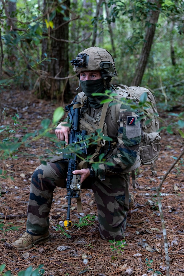 A French Marine with 3rd Marine Artillery Regiment, posts security during exercise Burmese Chase 25 at Marine Corps Base Camp Lejeune, North Carolina, Aug. 7, 2025. Burmese Chase is an annual U.S. led, multi-lateral training exercise comprised of integrating ground and air fires, infantry tactics and naval gunfire alongside NATO allies to enhance combat readiness and interoperability. (U.S. Marine Corps photo by Cpl. Marc Imprevert)