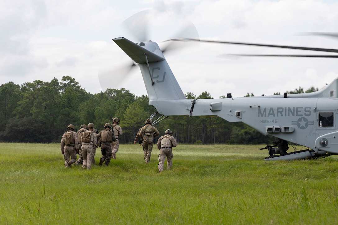 U.S. Marines and Sailors with 2nd Air Naval Gunfire Liaison Company, II Marine Expeditionary Force Information Group, and NATO allies, transport a simulated casualty into a CH-53E Super Stallion with Marine Heavy Helicopter Squadron 461, Marine Aircraft Group 29, 2nd Marine Aircraft Wing, during a casualty evacuation drill as part of exercise Burmese Chase 25 at Marine Corps Base Camp Lejeune, North Carolina, Aug. 7, 2025. Burmese Chase is an annual U.S. led, multi-lateral training exercise comprised of integrating ground and air fires, infantry tactics and naval gunfire alongside NATO allies to enhance combat readiness and interoperability. (U.S. Marine Corps photo by Cpl. Marc Imprevert)