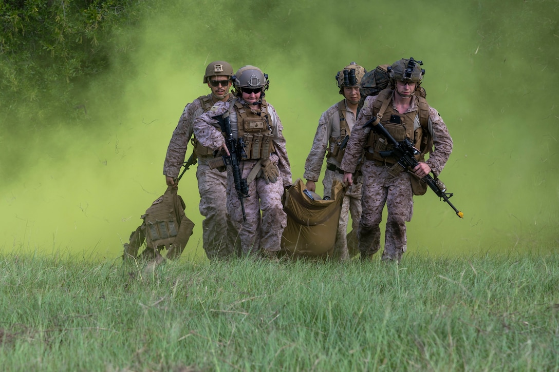 U.S. Marines and Sailors with 2nd Air Naval Gunfire Liaison Company, II Marine Expeditionary Force Information Group, transport a simulated casualty during a casualty evacuation drill as part of exercise Burmese Chase 25 at Marine Corps Base Camp Lejeune, North Carolina, Aug. 7, 2025. Burmese Chase is an annual U.S. led, multi-lateral training exercise comprised of integrating ground and air fires, infantry tactics and naval gunfire alongside NATO allies to enhance combat readiness and interoperability. (U.S. Marine Corps photo by Cpl. Marc Imprevert)