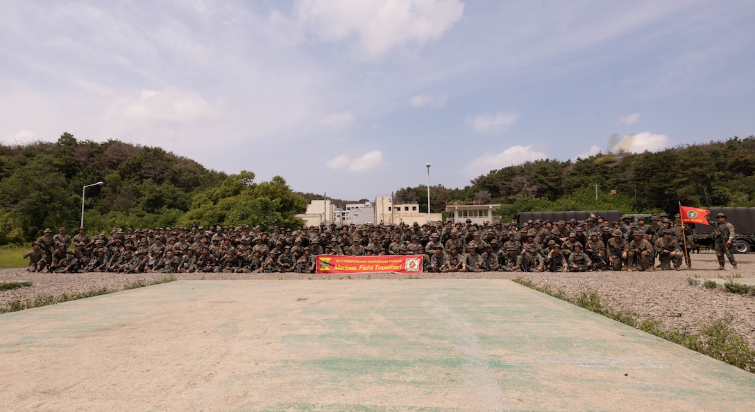 U.S. Marines with 2nd Battalion, 23rd Marines, forward deployed with 4th Marine Regiment, 3rd Marine Division as part of the Unit Deployment Program, and Republic of Korea Marines with 1st Marine Division, ROK Marine Corps, pose for a photo during the Korean Marine Exercise Program 25.2, Pohang, South Korea, Aug. 8, 2025. KMEP is conducted regularly between the ROK and U.S. Marine Corps to increase their combined capabilities through realistic training geared towards deterrence and maintaining peace in the Indo-Pacific.  (U.S. Marine Corps photo by Cpl. Kanoa Thomas)