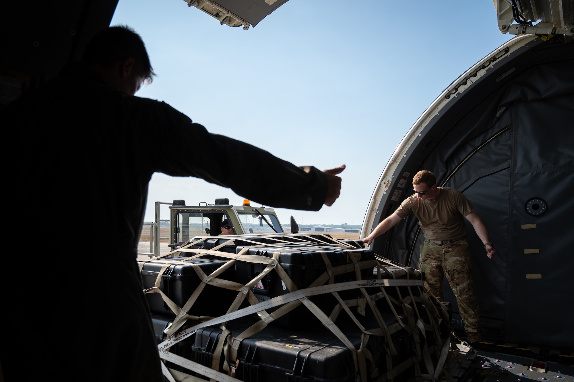 U.S. Air Force Tech. Sgt. David Simpler, right, and Master Sgt. Andrew Abney, boom operators with the 2nd Air Refueling Squadron, move equipment off a K-Loader onto a KC-46 Pegasus aircraft during Talisman Sabre 25 in Northern Territory, Australia, July 25, 2025. Talisman Sabre is the largest bilateral military exercise between Australia and the United States, advancing a safe and secure Indo-Pacific by strengthening relationships and interoperability among key Allies and partners, while enhancing collective capabilities to respond to a wide array of potential security concerns. (U.S. Air Force photo by Tech. Sgt. Philip Bryant)