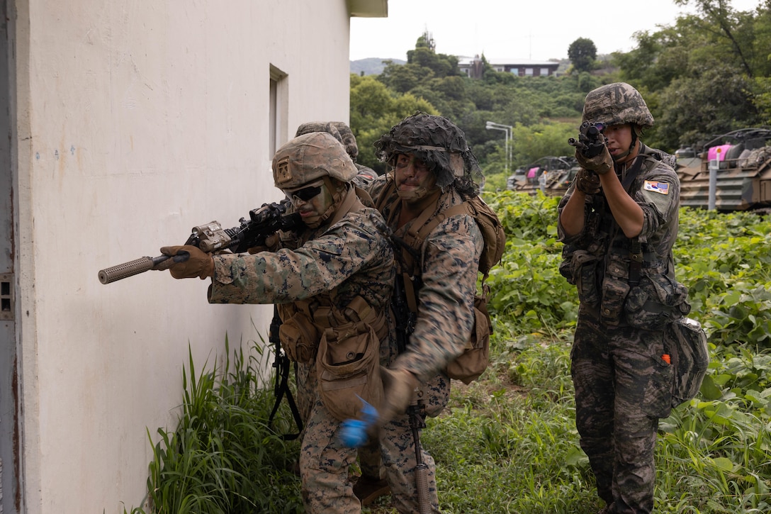 U.S. Marines with 2nd Battalion, 23rd Marines, forward deployed with 4th Marine Regiment, 3rd Marine Division as part of the Unit Deployment Program, and Republic of Korea Marines with 1st Marine Division, ROK Marine Corps, assault into a building during military operations on urban terrain training during the Korean Marine Exercise Program 25.2, Pohang, South Korea, Aug. 8, 2025. KMEP is conducted regularly between the ROK and U.S. Marine Corps to increase their combined capabilities through realistic training geared towards deterrence and maintaining peace in the Indo-Pacific.  (U.S. Marine Corps photo by Cpl. Kanoa Thomas)