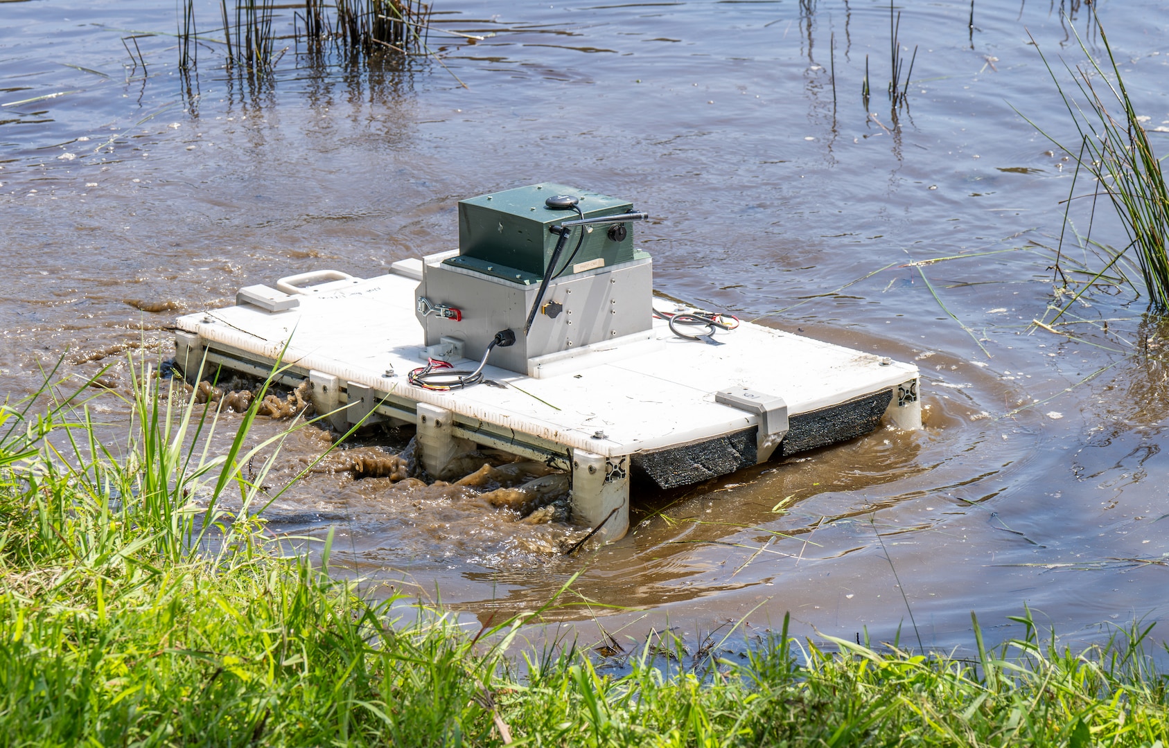 DAHLGREN, Va. – An unmanned surface vessel, designed and built by Science and Engineering Apprenticeship Program interns, operates during a demonstration at Hideaway Pond. The project challenged students to create a low-cost system using commercial off-the-shelf components. (Morgan Lee Tabor/NSWCDD Photo)