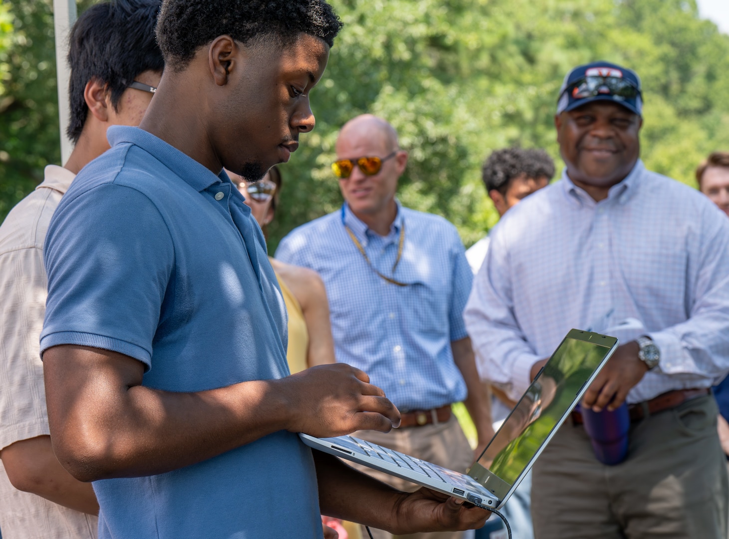 DAHLGREN, Va. – A Science and Engineering Apprenticeship Program intern operates a laptop to run and monitor an unmanned surface vessel during the program’s final demonstration at Naval Surface Warfare Center Dahlgren Division (NSWCDD). (Morgan Lee Tabor/NSWCDD Photo)