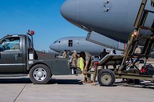 U.S. Air Force Staff Sgt. Brian Izaguirre, a crew chief with the 305th Aircraft Maintenance Squadron, Joint Base McGuire-Dix-Lakehurst, New Jersey, attaches maintenance stairs to a tow truck during Talisman Sabre 25 in Northern Territory, Australia, July 14, 2025. This training ensures that Air Mobility Command can respond rapidly and effectively to common challenges in dynamic situations. Talisman Sabre is the largest bilateral military exercise between Australia and the United States, that advances a safe and secure Indo-Pacific by strengthening relationships and interoperability among key allies and partners, while enhancing collective capabilities to respond to a wide array of potential security concerns. (U.S. Air Force photo by Senior Airman Clare Werner)