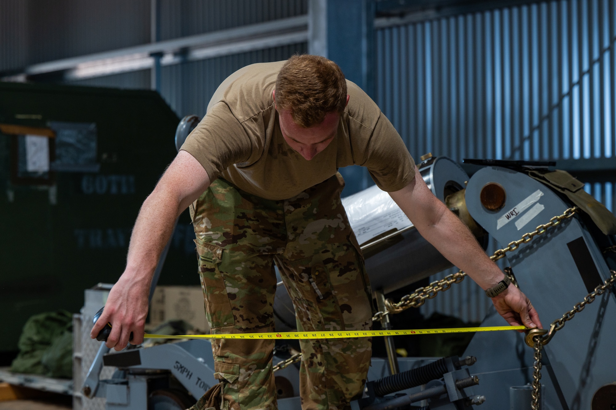 U.S. Air Force Tech. Sgt. David Simpler, 2nd Air Refueling Squadron boom operator and Talisman Sabre 2025 operations superintendent, measures a piece of palletized cargo during KC-46 operations in support of TS25 in Northern Territory, Australia, July 25, 2025. Talisman Sabre is the largest bilateral military exercise between Australia and the United States, that advances a safe and secure Indo-Pacific by strengthening relationships and interoperability among key Allies and partners, while enhancing collective capabilities to respond to a wide array of potential security concerns. (U.S. Air Force photo by Senior Airman Clare Werner)