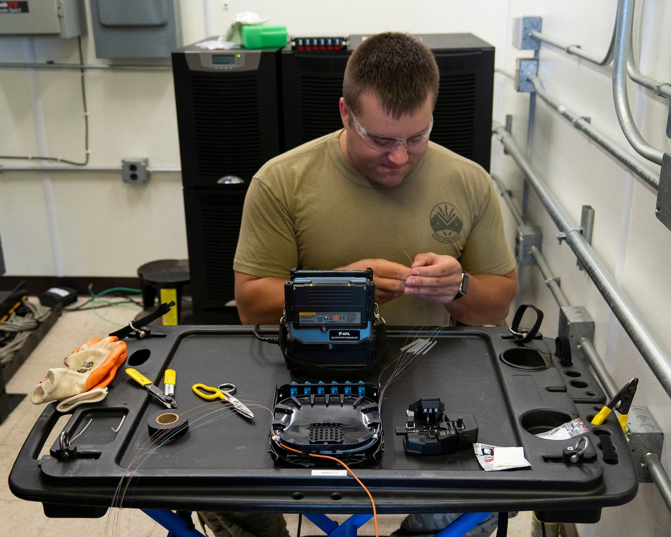 U.S. Air Force Tech. Sgt. Benjamin Dutting, a cable and antenna technician with the 212th Engineering Installation Squadron (EIS), splices 12-strand fiber optic cable during an infrastructure upgrade on Otis Air National Guard Base, Massachusetts, August 8, 2025.