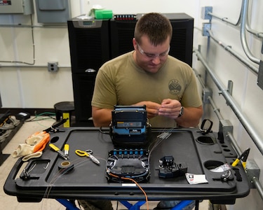 U.S. Air Force Tech. Sgt. Benjamin Dutting, a cable and antenna technician with the 212th Engineering Installation Squadron (EIS), splices 12-strand fiber optic cable during an infrastructure upgrade on Otis Air National Guard Base, Massachusetts, August 8, 2025.