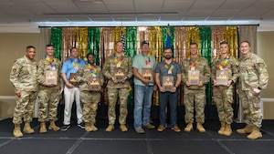 Group of people on stage with awards.