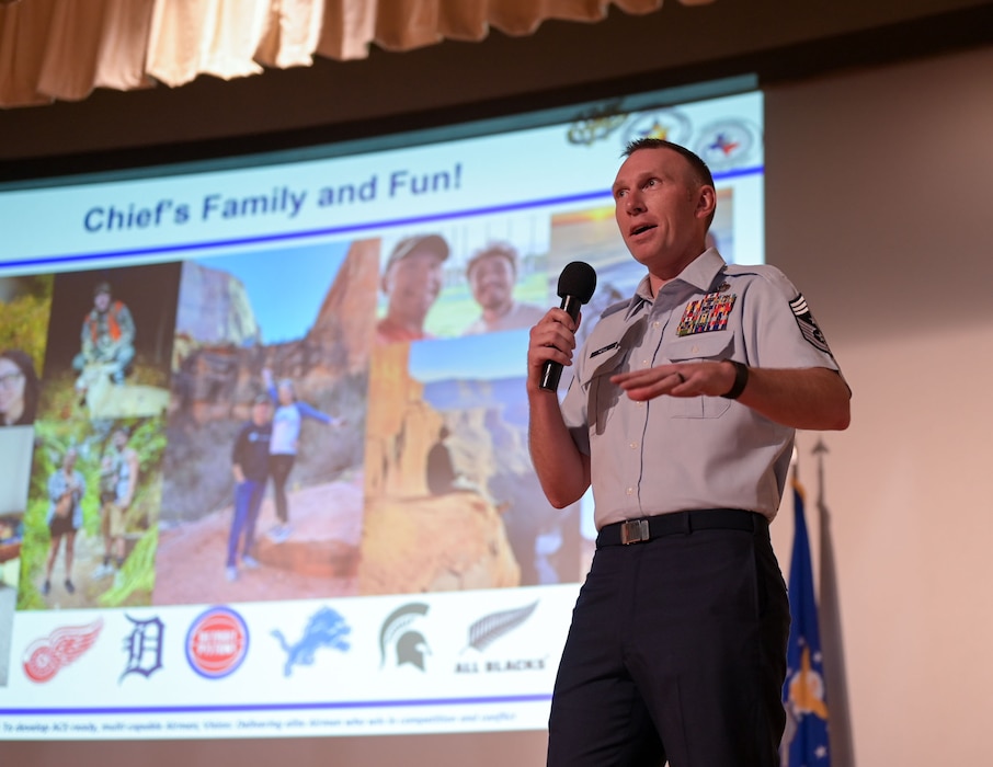 U.S. Air Force Chief Master Sgt. Derek J. Neill, 17th Training Wing command chief, speaks at the Commander’s All-Call and 2nd Quarterly Awards Ceremony at the base theater, Goodfellow Air Force Base, Texas, Aug. 8, 2025. Neill spoke on his career progression in the Air Force and how all Airmen learn resiliency through their own careers. (U.S. Air Force photo by Senior Airman Evelyn D’Errico)
