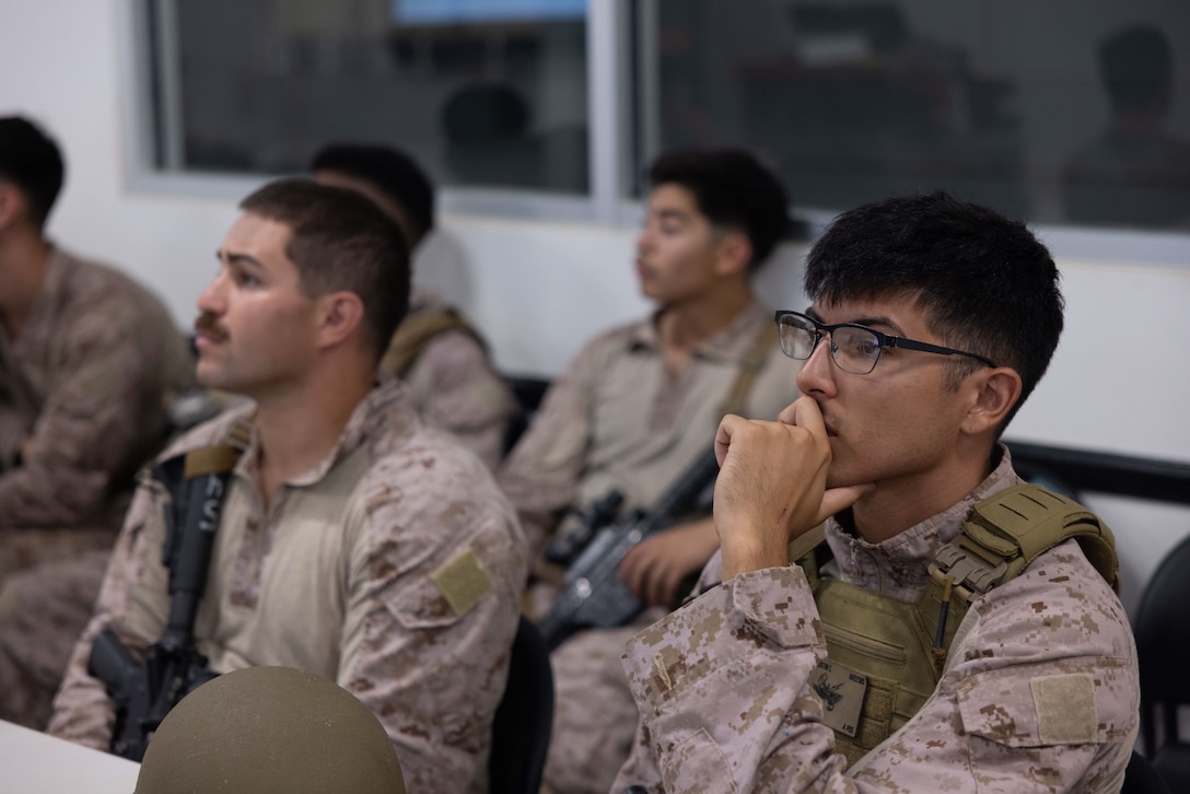 U.S. Marines with 4th Air Naval Gunfire Liaison Company, Force Headquarters Group, Marine Corps Forces Reserve, receive a mission brief during exercise Burmese Chase 25 at Marine Corps Base Camp Lejeune, North Carolina, Aug. 8, 2025. Burmese Chase is an annual U.S. led, multi-lateral training exercise comprised of integrating ground and air fires, infantry tactics and naval gunfire alongside NATO allies to enhance combat readiness and interoperability. (U.S. Marine Corps photo by LCpl. Weston Lindstrom.)