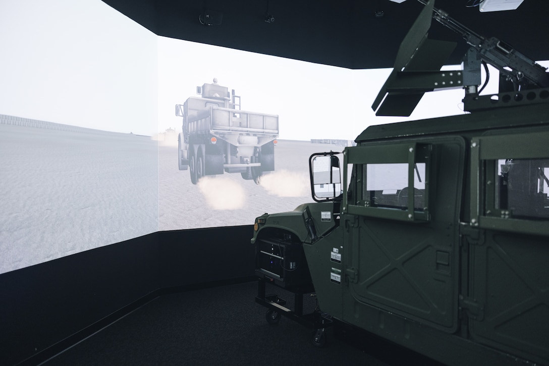 Students with the Lejeune High School Marine Corps Junior Reserve Officers’ Training Corps drive a simulated High Mobility Multipurpose Wheeled Vehicle during a visit to the Indoor Simulated Marksmanship Trainer (ISMT) on Marine Corps Base Camp Lejeune, Aug. 5, 2025. Students visited the ISMT to gain a higher understanding of Marine Corps tactics and weapons systems. (U.S. Marine Corps photo by Cpl. Loriann Dauscher)