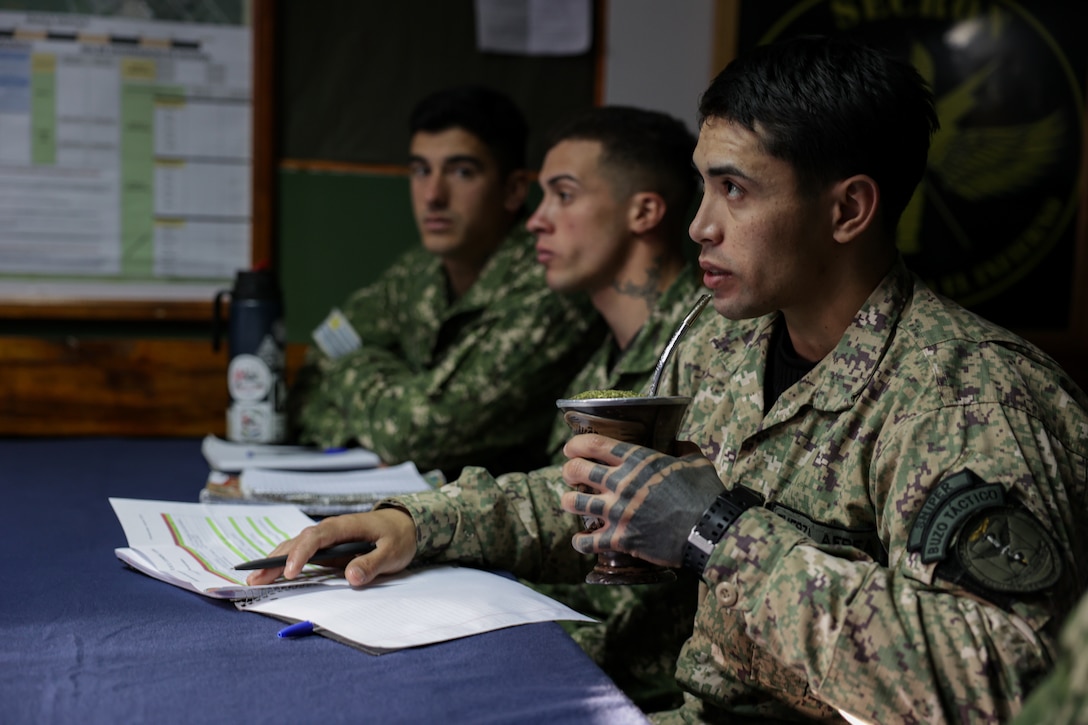 Uruguayan service members listen in during a subject matter expert exchange with members of the Uruguayan marine corps in Uruguay, August 11, 2025. This subject matter expert exchange enhances the training and readiness standards for the United States and Uruguay as well as facilitating the exchange of formalized readiness standards between both countries. (U.S. Marine Corps photo by Sgt. Eduardo Delatorre)