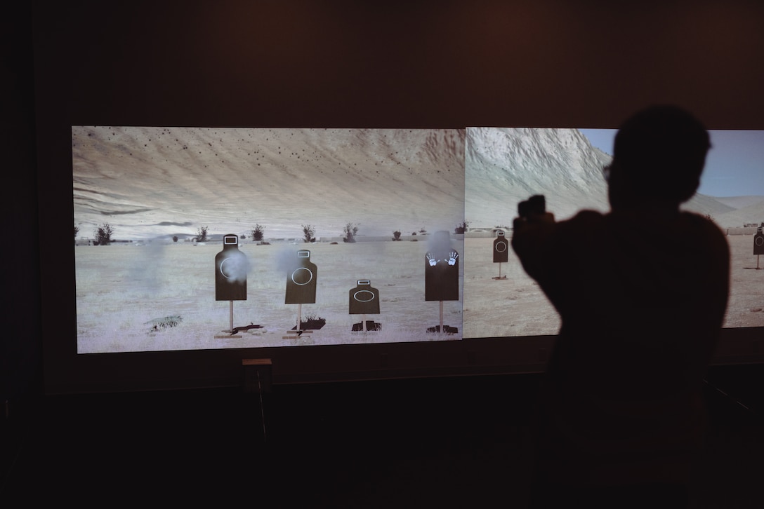 A student with the Lejeune High School Marine Corps Junior Reserve Officers’ Training Corps dryfires a training M18 pistol during a visit to the Indoor Simulated Marksmanship Trainer (ISMT) on Marine Corps Base Camp Lejeune, Aug. 5, 2025. Students visited the ISMT to gain a higher understanding of Marine Corps tactics and weapons systems. (U.S. Marine Corps photo by Cpl. Loriann Dauscher)