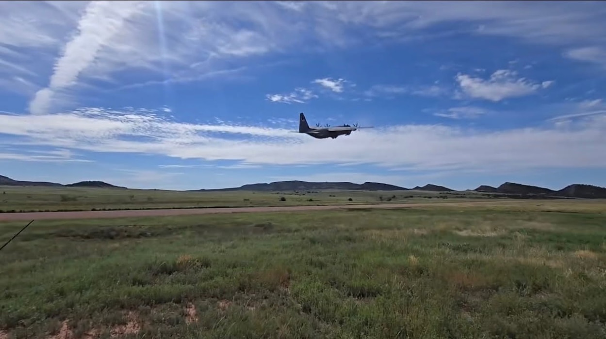 A military aircraft takes off into the sky.