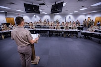 Command Sgt. Maj. Eric Olsen, standing, U.S. Army South senior enlisted advisor, speaks to U.S. and Colombian participants of Programa Integral para Suboficiales de Alta Jerarquía (PISAJ) 21 at the South Carolina National Guard McCrady Training Center in Columbia, S.C., Aug. 11, 2025. PISAJ is a biannual, partner nation-funded initiative aligned with U.S. Southern Command’s Theater Campaign Plan and directly supports the Colombian Army’s transformation to align its noncommissioned officer corps with globally recognized standards. (U.S. Army photo by Staff Sgt. Joshua Taeckens)
