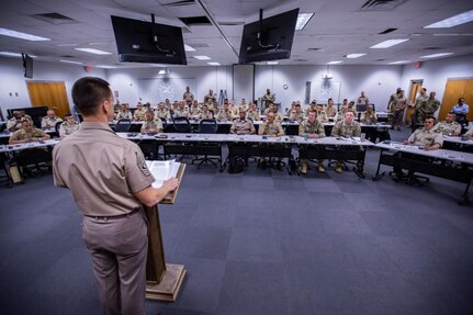 Command Sgt. Maj. Eric Olsen, standing, U.S. Army South senior enlisted advisor, speaks to U.S. and Colombian participants of Programa Integral para Suboficiales de Alta Jerarquía (PISAJ) 21 at the South Carolina National Guard McCrady Training Center in Columbia, S.C., Aug. 11, 2025. PISAJ is a biannual, partner nation-funded initiative aligned with U.S. Southern Command’s Theater Campaign Plan and directly supports the Colombian Army’s transformation to align its noncommissioned officer corps with globally recognized standards. (U.S. Army photo by Staff Sgt. Joshua Taeckens)