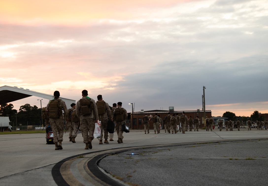 U.S. Marines assigned to 2nd Low Altitude Air Defense Battalion, Marine Air Control Group 28, 2nd Marine Aircraft Wing, exit a commercial aircraft at Marine Corps Air Station Cherry Point, North Carolina, July 24, 2025.