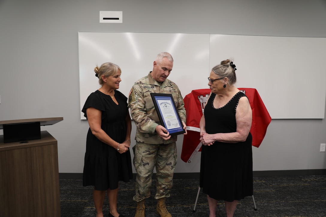 U.S. Army Maj. Gen. Haldane B. Lamberton, Kentucky's adjutant general, presents the Honorary Guardsman award to Reva and Theresa Feldman, in honor of Nick Feldman, during a ceremony at Boone National Guard Center in Frankfort, Kentucky, Aug. 5, 2025.