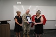 U.S. Army Maj. Gen. Haldane B. Lamberton, Kentucky's adjutant general, presents the Honorary Guardsman award to Reva and Theresa Feldman, in honor of Nick Feldman, during a ceremony at Boone National Guard Center in Frankfort, Kentucky, Aug. 5, 2025.
