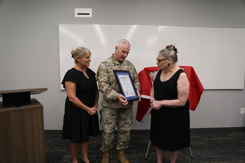 U.S. Army Maj. Gen. Haldane B. Lamberton, Kentucky's adjutant general, presents the Honorary Guardsman award to Reva and Theresa Feldman, in honor of Nick Feldman, during a ceremony at Boone National Guard Center in Frankfort, Kentucky, Aug. 5, 2025.