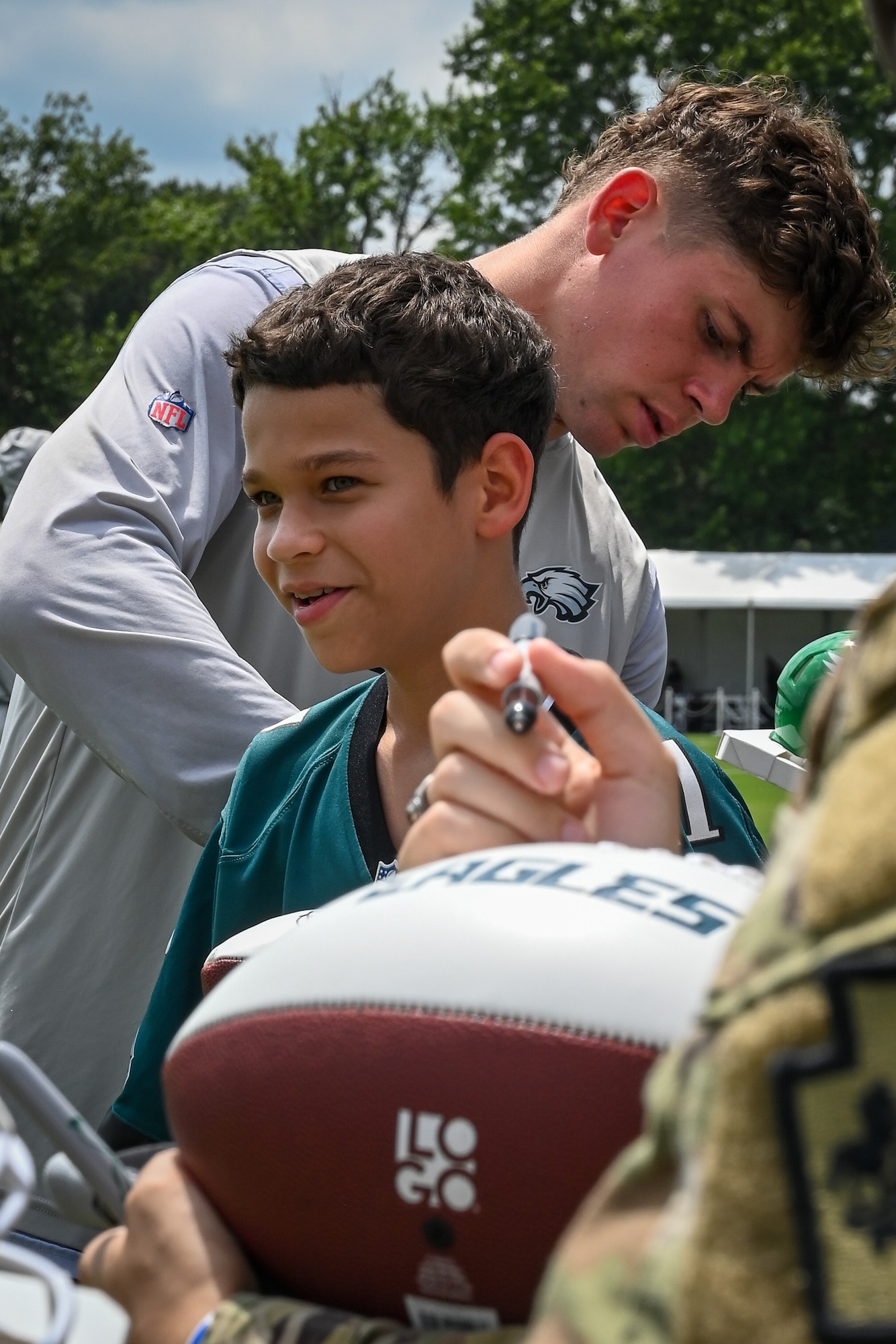 Philadelphia Eagles cornerback Cooper Dejean signs autographs after training camp at the NovaCare Complex in Philadelphia, July 26, 2025. In collaboration with the USOs of Pennsylvania, New Jersey, and Delaware, the Eagles welcomed military personnel from every branch to training camp for a day of gratitude and celebration.(U.S. Air National Guard photo by Staff Sgt. Charles Casner)