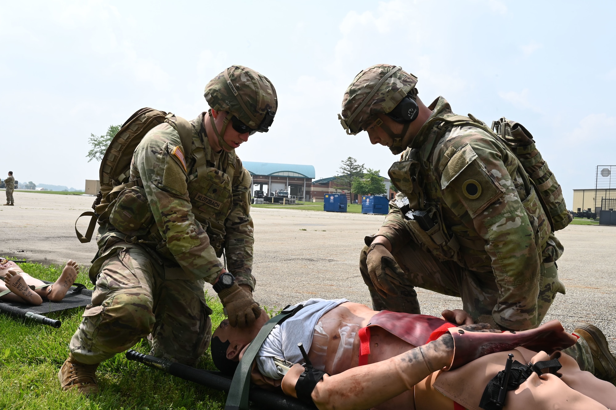 Soldiers with the 1st Battalion, 148th Infantry Regiment, 37th Infantry Brigade Combat Team provide aid to a casualty dummy June 7, 2025, at the 178th Ohio Air National Guard Base in Springfield, Ohio, during Exercise Relentless Valor. The scenario is part of a large-scale joint medical exercise focused on enhancing readiness through realistic training in contested environments. (U.S. Air National Guard photo by Staff Sgt. Colin Simpson)