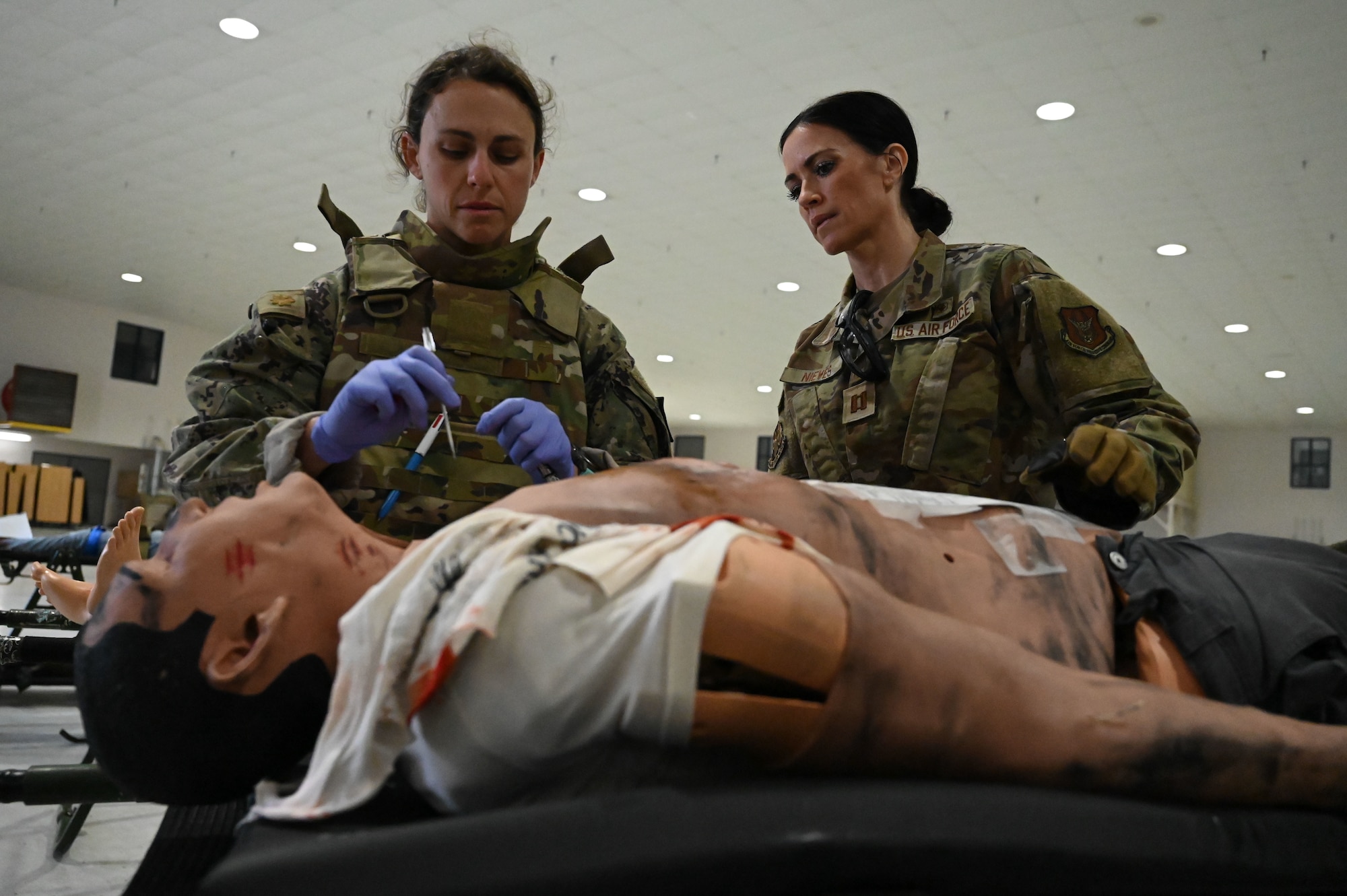 U.S. Airmen assigned to the 445th Aeromedical Staging Squadron conducted initial evaluation and first aid on role-players June 7, 2025, at the 178th Ohio Air National Guard Base in Springfield, Ohio, as part of Exercise Relentless Valor. The large-scale medical exercise ensures higher command readiness requirements were met through coordinated medical care on the ground and in the air. (U.S. Air National Guard photo by Staff Sgt. Colin Simpson)