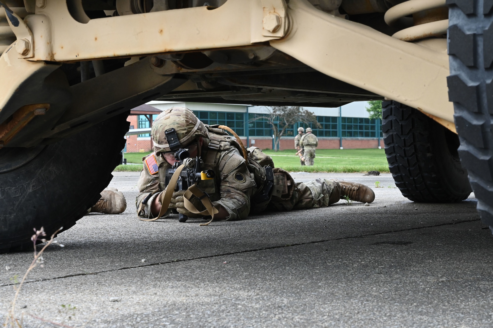 Soldiers with the 1st Battalion, 148th Infantry Regiment, 37th Infantry Brigade Combat Team scan for simulated combatants through the scope of a rifle June 7, 2025, at the 178th Ohio Air National Guard Base in Springfield, Ohio, during Exercise Relentless Valor. The scenario is part of a large-scale joint medical exercise focused on enhancing readiness through realistic training in contested environments. (U.S. Air National Guard photo by Staff Sgt. Colin Simpson)