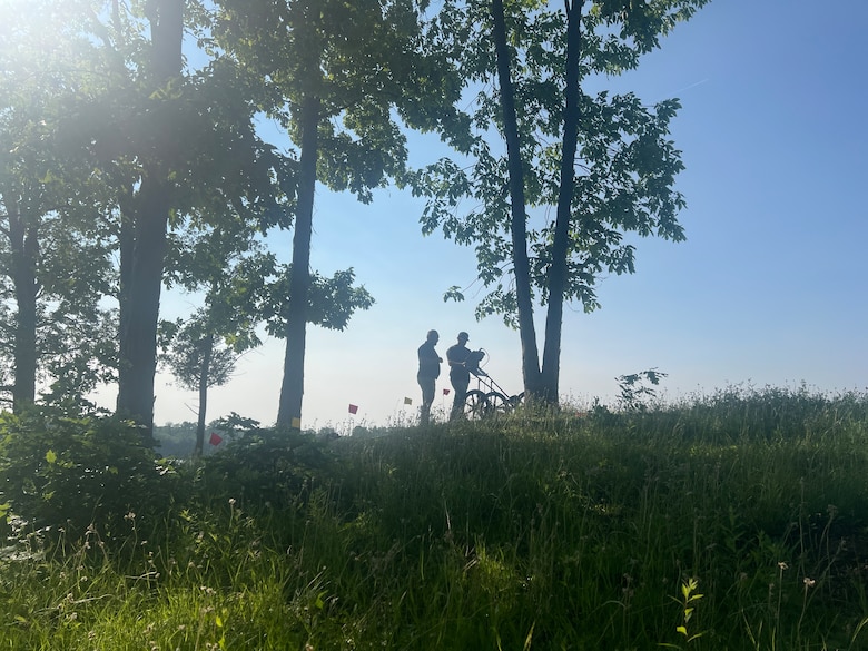 Archaeologists from ERDC's Construction Engineering Research Laboratory use specialized equipment during a geophysical survey to collect data and determine if the site was a previous burial location.