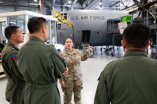 person talking to group in front of an aircraft