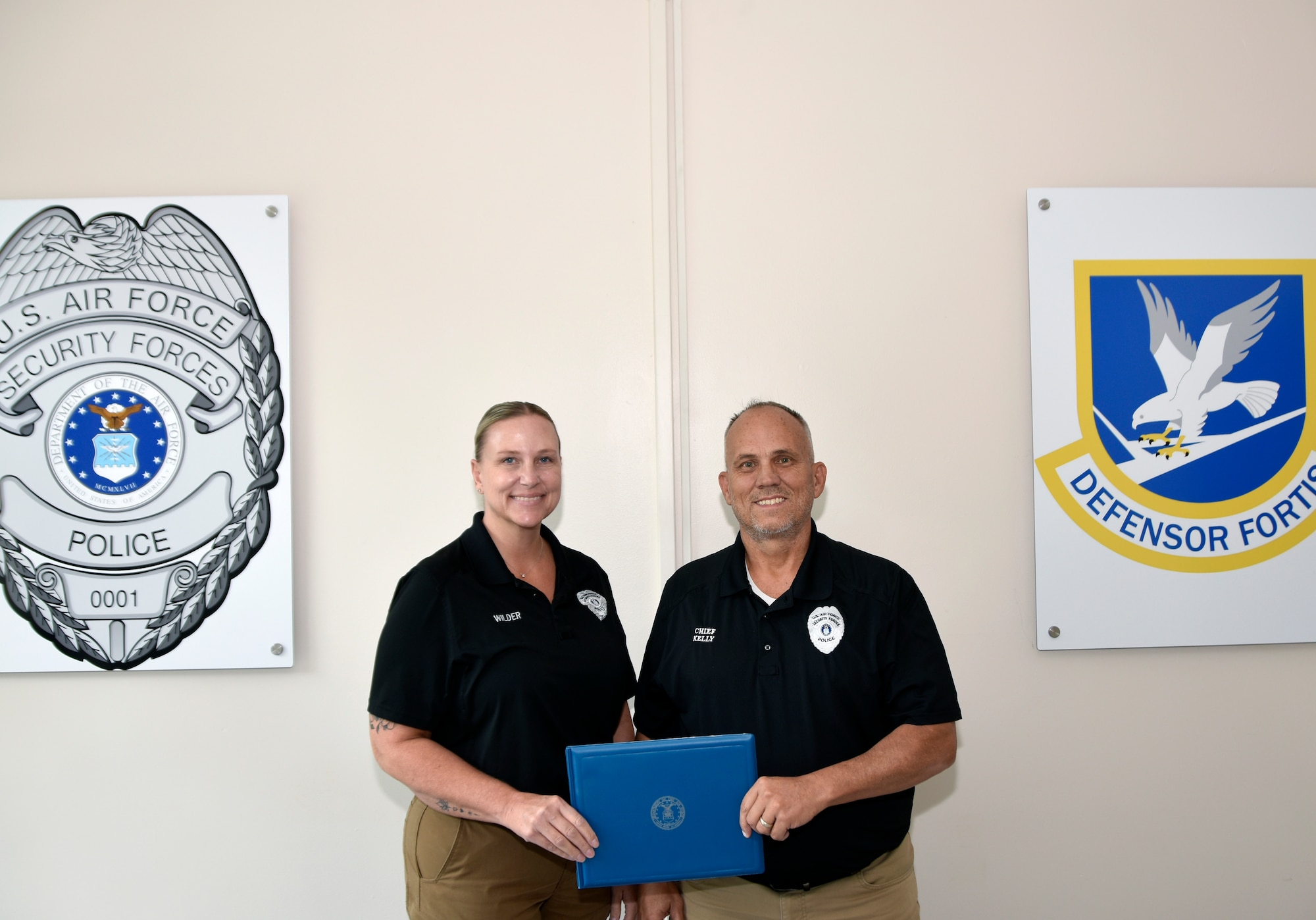 Arnold Air Force Base Security Forces Administrative Lt. Holly Wilder, left, receives a certificate Aug. 11, 2025, from Arnold AFB Security Forces Director Chief Ray Kelly recognizing Wilder for her quick and potentially lifesaving actions during a recent off-duty outing at a Murfreesboro restaurant. On July 21, 2025, Wilder performed the Heimlich maneuver of a fellow restaurant patron who was choking. (U.S. Air Force photo by Brad Hicks)
