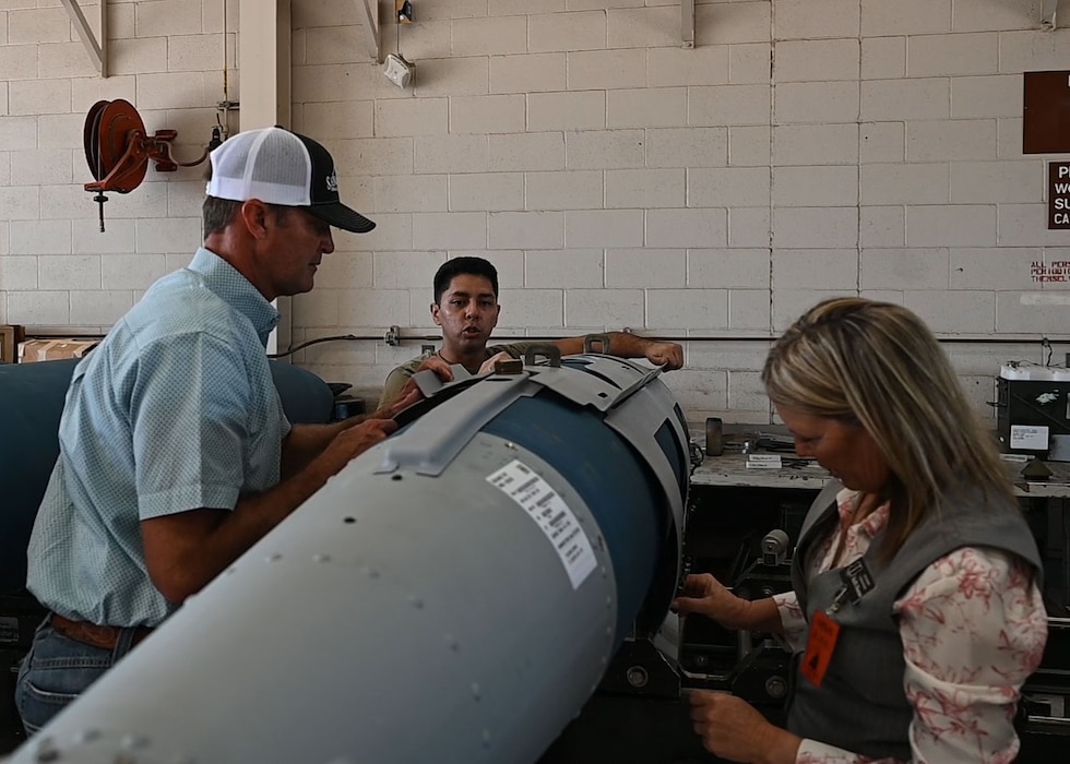 17th Training Wing honorary commanders assemble a Joint Direct Attack Munition under the supervision of a 7th Munitions Squadron Airman at Dyess Air Force Base, Texas, Aug. 6, 2025. The 7th Maintenance Group's major role is to provide mission-capable B-1B aircraft, properly configured and on time to meet any of the Wing's missions. (U.S. Air Force photo by Staff Sgt Nathan Call)