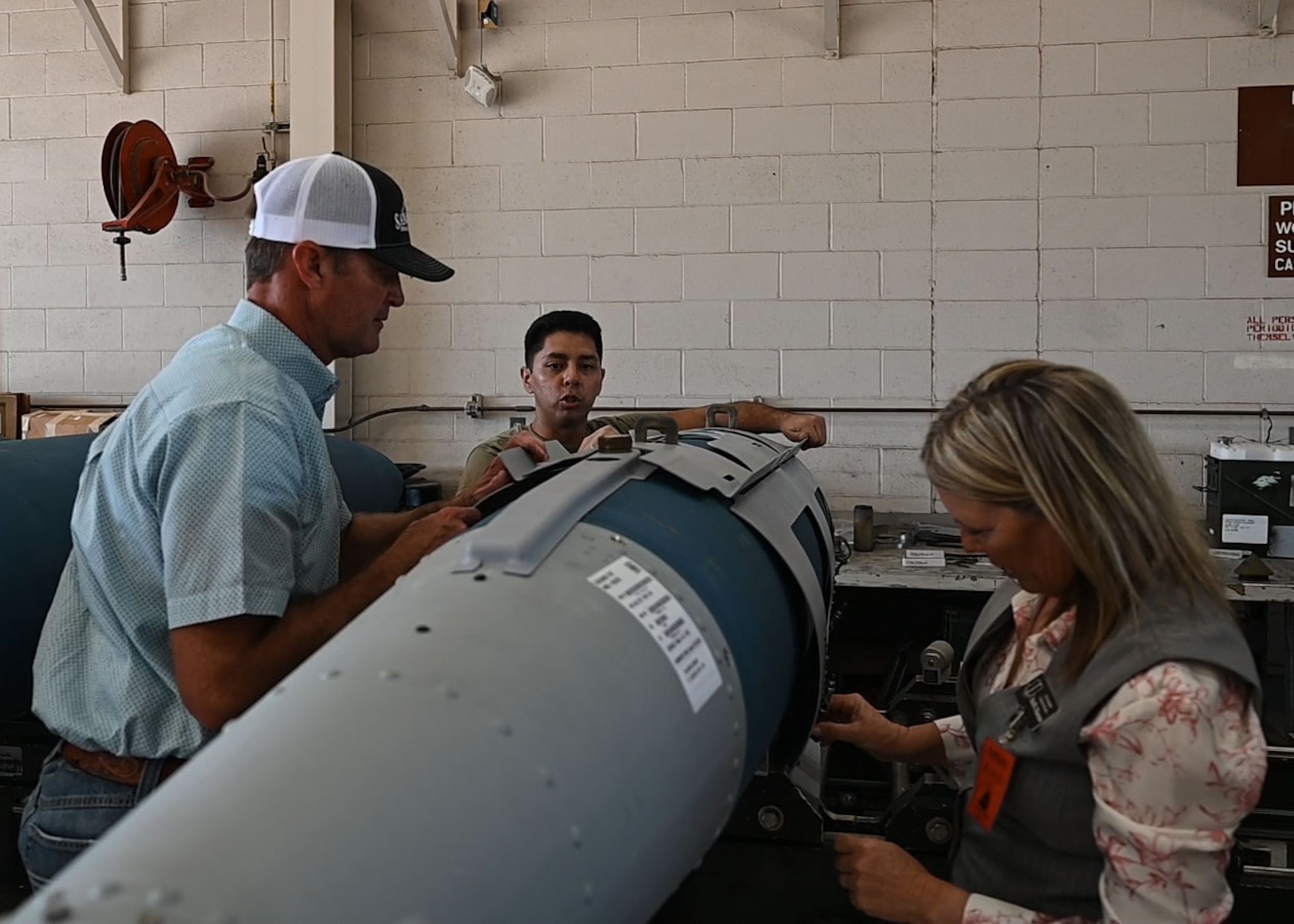 17th Training Wing honorary commanders assemble a Joint Direct Attack Munition under the supervision of a 7th Munitions Squadron Airman at Dyess Air Force Base, Texas, Aug. 6, 2025. The 7th Maintenance Group's major role is to provide mission-capable B-1B aircraft, properly configured and on time to meet any of the Wing's missions. (U.S. Air Force photo by Staff Sgt Nathan Call)