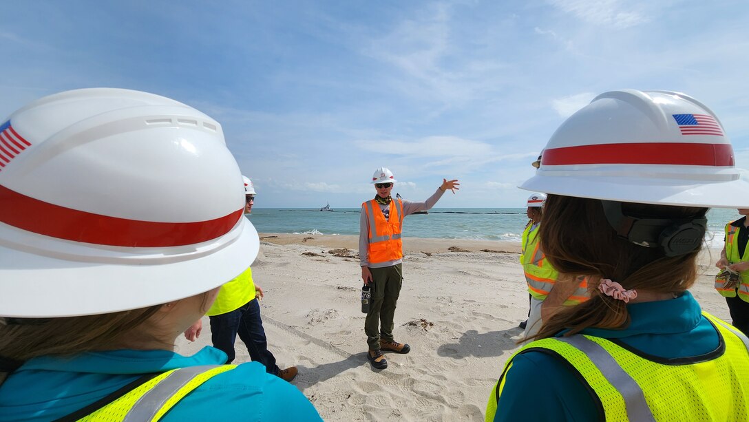 USACE Jacksonville District Senior Project Manager Chris Ren explains dredging operations in the borrow area and sand placement to the Canaveral Sand Bypass (CSB) project delivery team members and non-federal sponsor representatives on a site visit of CSB operations.