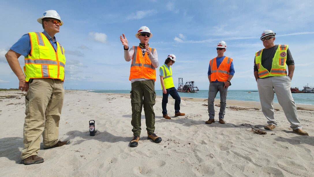 USACE Jacksonville District Senior Project Manager Chris Ren explains dredging operations in the borrow area and sand placement to the Canaveral Sand Bypass (CSB) project delivery team members and non-federal sponsor representatives on a site visit of CSB operations.