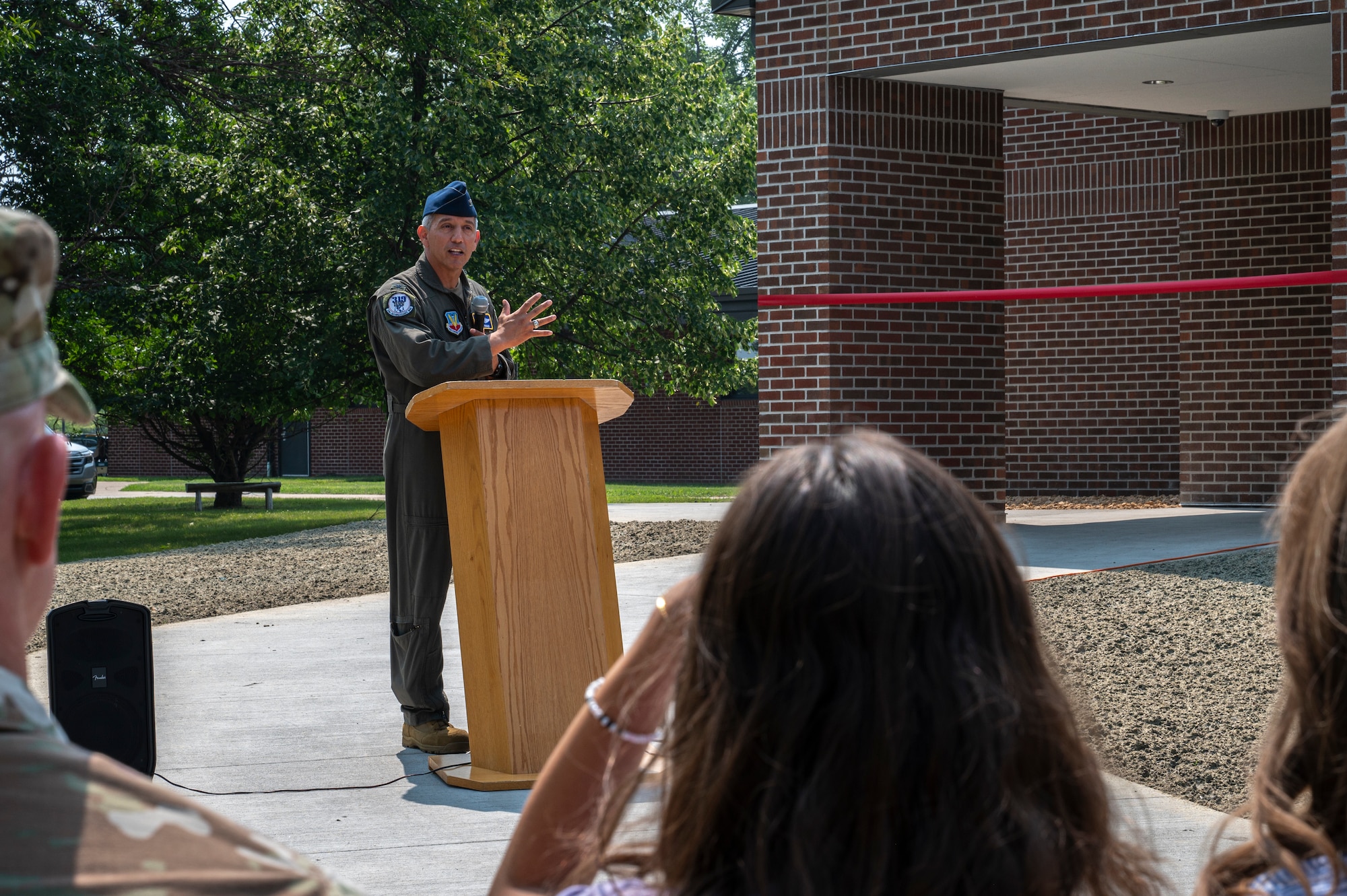 A picture of a man standing in front of a crowd.