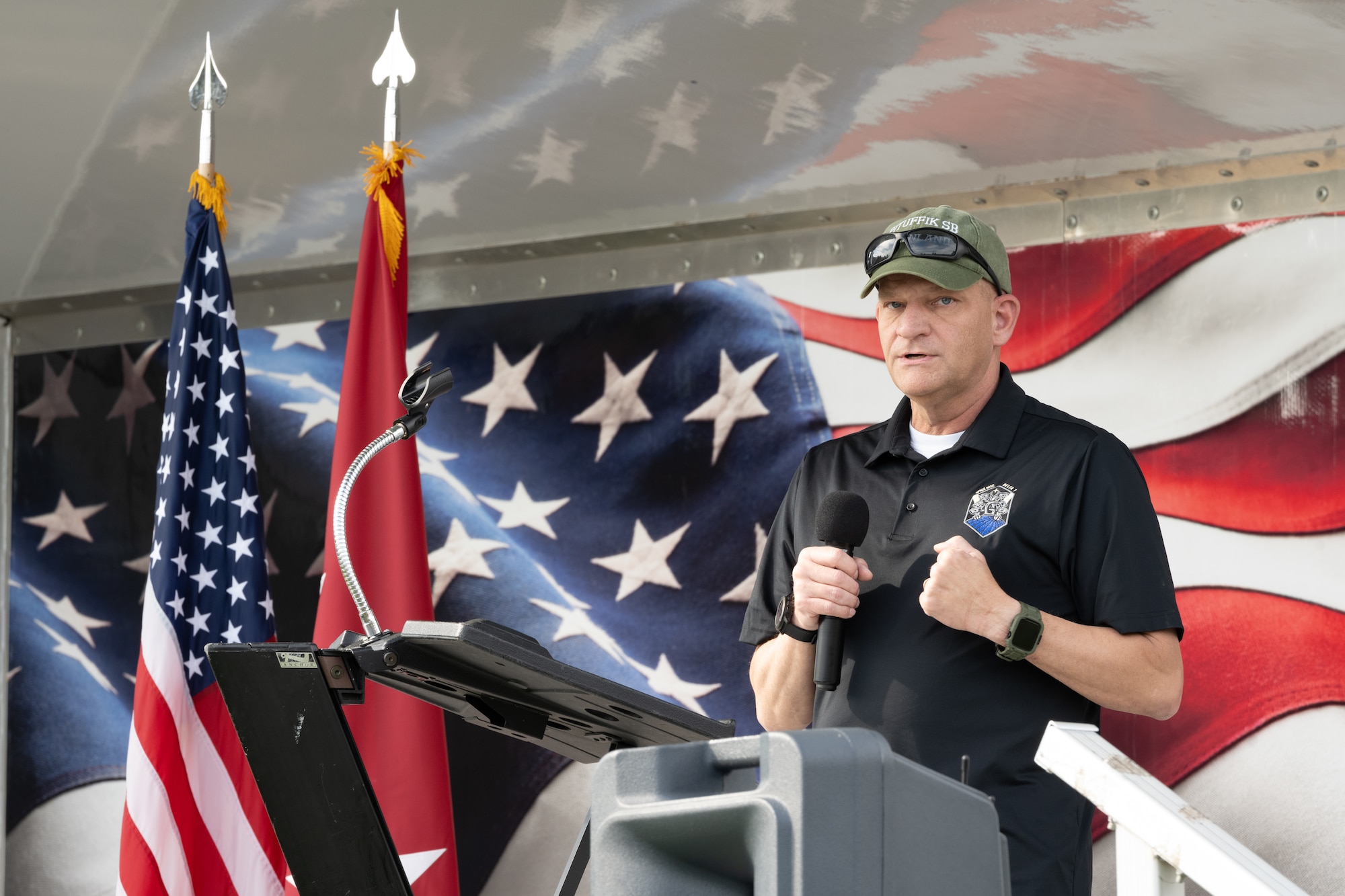 Col. Klock gives his opening statement while standing on the stage.