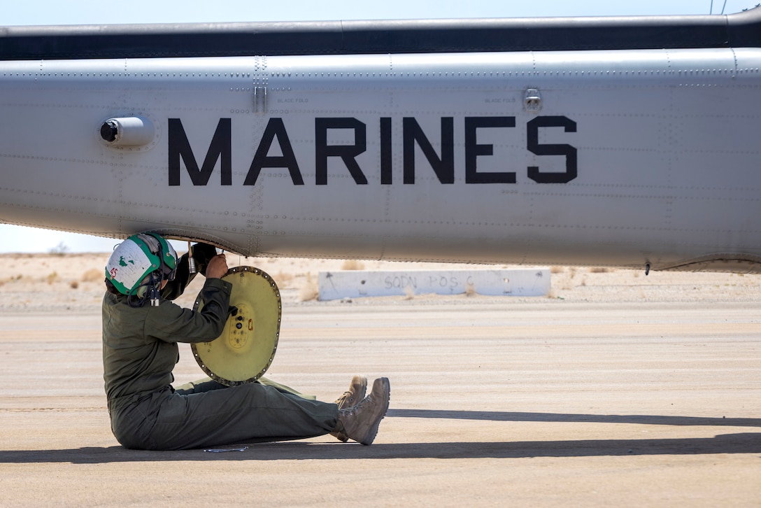U.S. Marine Corps Cpl. Daija Beltransalas, an aircraft avionics technician with Marine Light Attack Helicopter Squadron (HMLA) 367, Marine Aircraft Group 39, 3rd Marine Aircraft Wing, services an AH-1Z Viper assigned to HMLA-369, MAG-39, during  Service Level Training Exercise 4-25 at Marine Corps Air-Ground Combat Center,  Twentynine Palms, California, Aug. 10, 2025. SLTE 4-25 is designed to be a challenging, realistic training environment that produces combat-ready forces capable of operating as an integrated Marine Air Ground Task Force across all domains of military operations. Beltransalas is a native of California. (U.S. Marine Corps photo by Lance Cpl. Seferino Gamez)