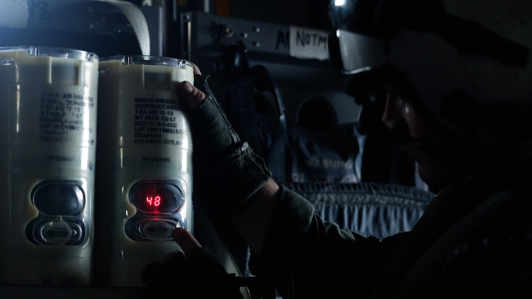 U.S. Marine Corps Sgt. Mason Workman, an aerial observer with Marine Medium Tiltrotor Squadron (VMM) 265 (Rein.), 31st Marine Expeditionary Unit, sets parameters for the directional command activated sonobuoy system buoy during anti-submarine warfare training, in the Philippine Sea, Aug. 8, 2025.