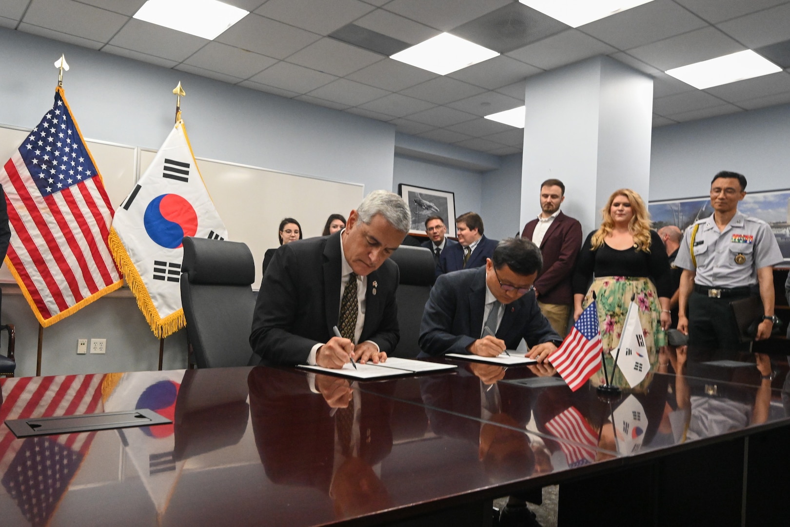 The Defense POW/MIA Accounting Agency Director, Kelly McKeague, left, and the Republic of Korea Ministry of National Defense Agency for KIA Recovery and Identification Director, Keun-Won Lee, sign a Memorandum of Understanding in Arlington, Virginia, solidifying their agencies’ commitment to recovering and identifying remains of service members missing from the Korean War, Aug. 6, 2025.