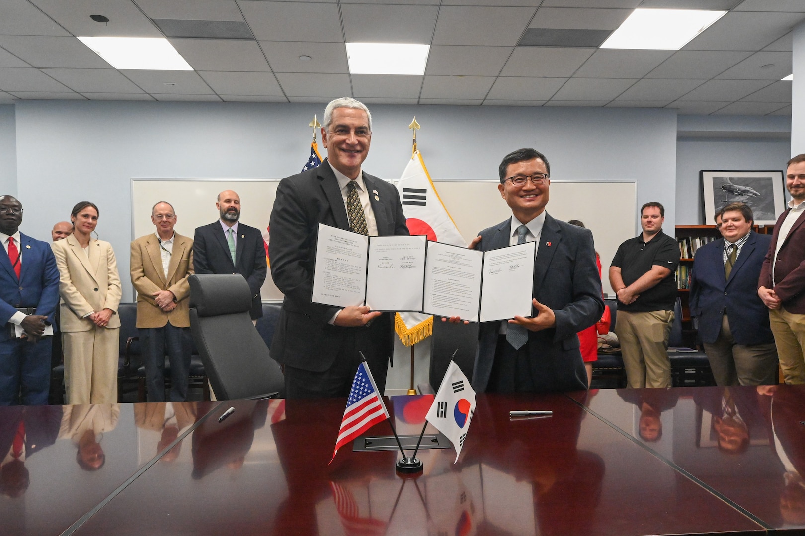 The Defense POW/MIA Accounting Agency Director, Kelly McKeague, left, and the Republic of Korea Ministry of National Defense Agency for KIA Recovery and Identification Director, Keun-Won Lee, present the signed Memorandum of Understanding in Arlington, Virginia, solidifying their agencies’ commitment to recovering and identifying remains of service members missing from the Korean War, Aug. 6, 2025.